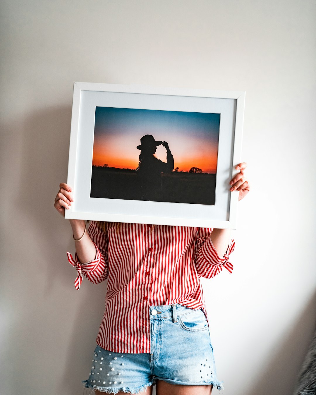 person holding framed photo