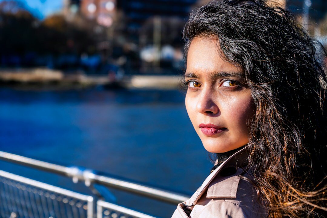 Portrait of a young Chilean woman photographer holding a camera