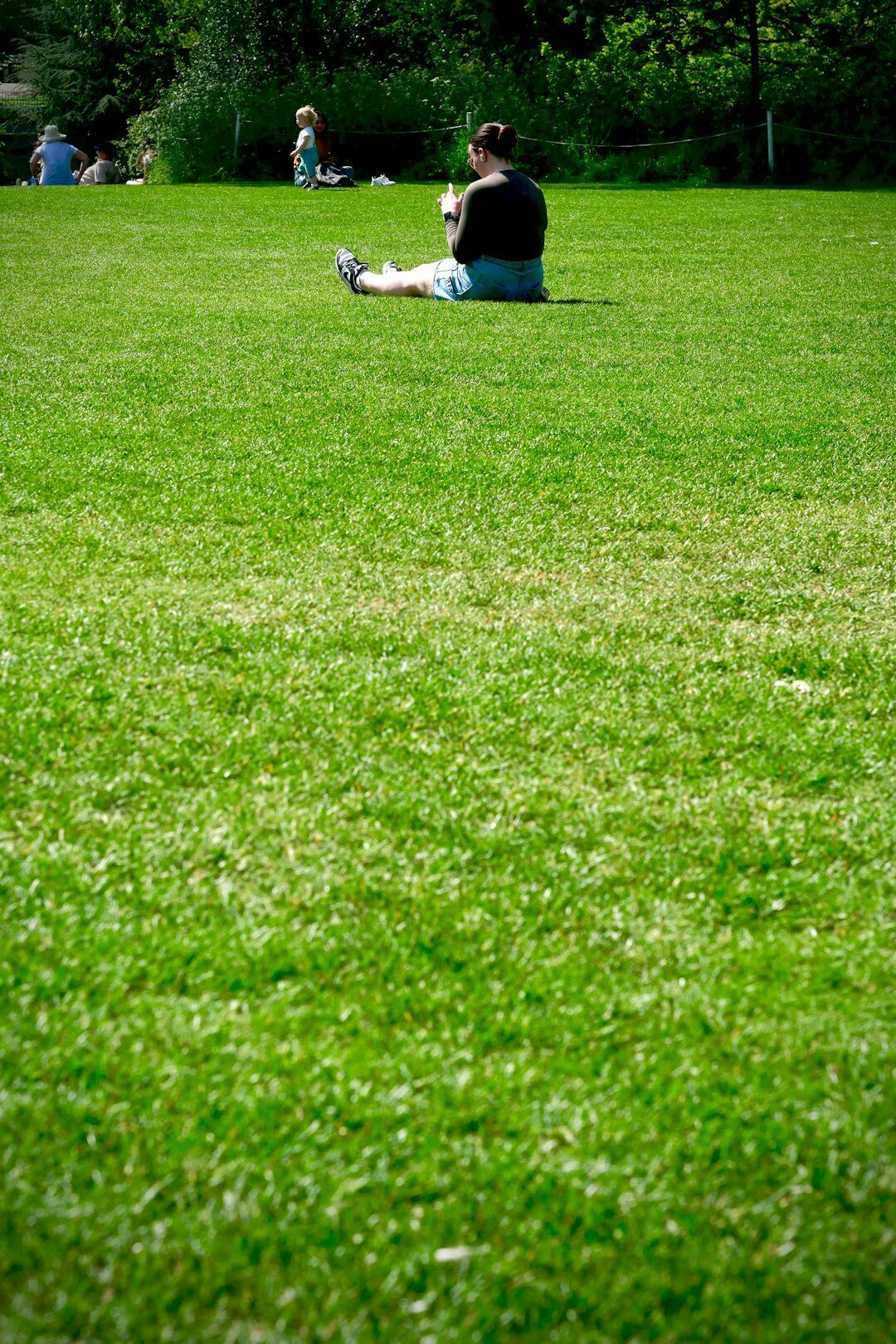 person reading book in park
